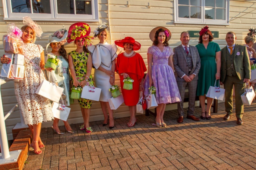 group of people dressed up for ladies day