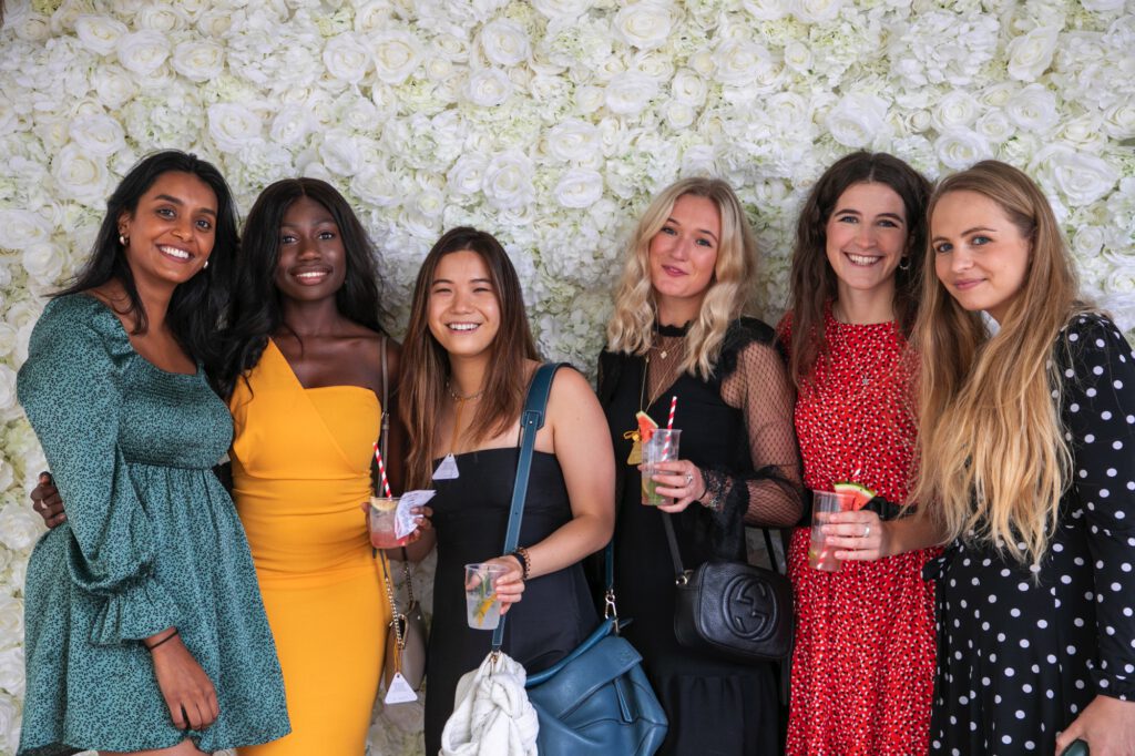 group-of-women-in-front-of-flower-wall