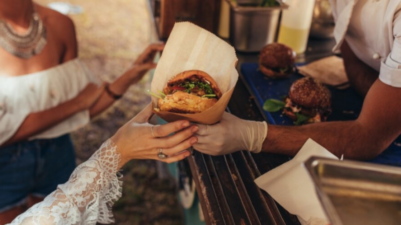 street food burger being handed to a customer
