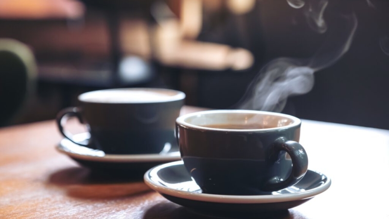 two coffee cups sitting on table