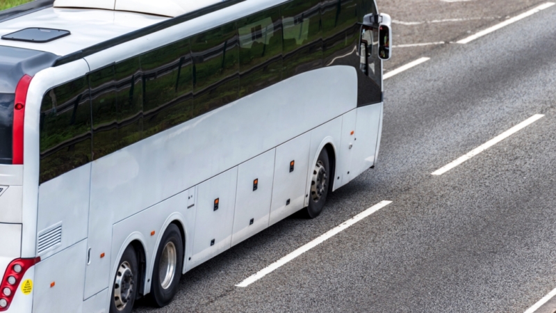 white coach driving along