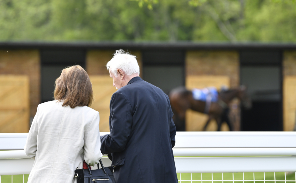 couple standing and watching the racing