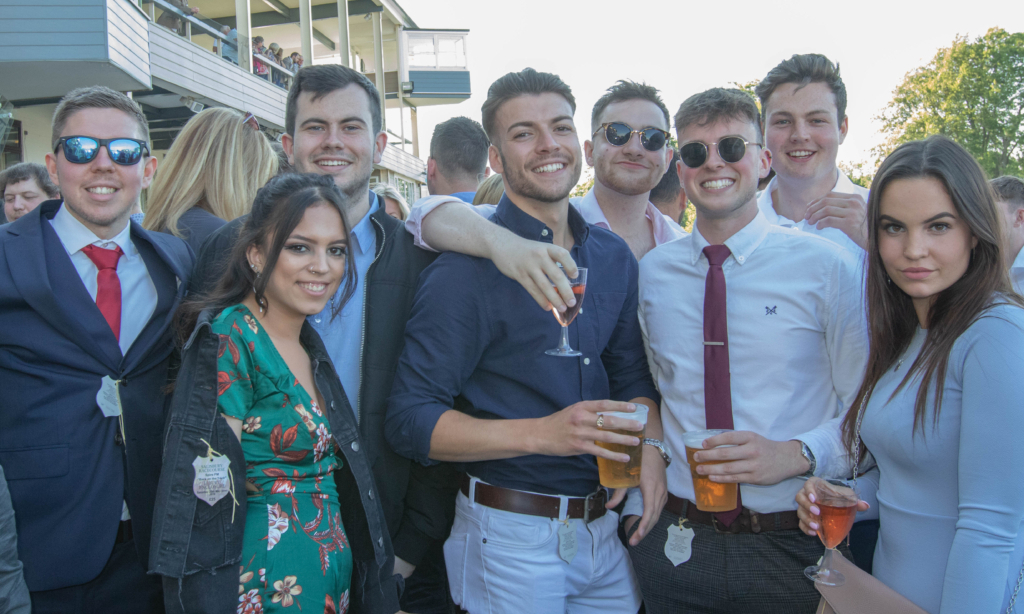 group of friends having fun at the racecourse
