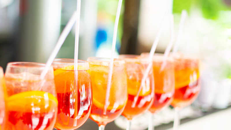 Photo of sweet red cocktails on bar during summer time.